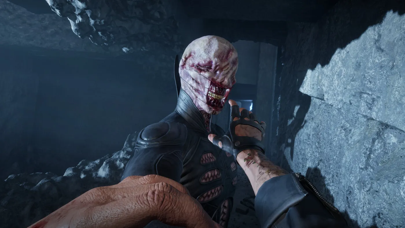 A player grapples a scarred enemy in a stone corridor in Hellraiser: Revival